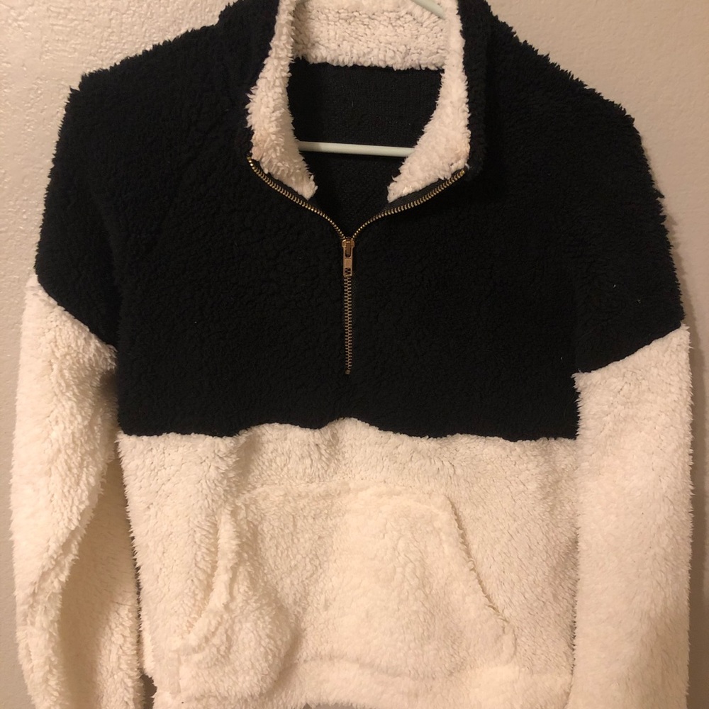 Black and white quarter zip. Fits like a small.